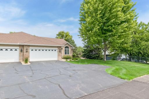 Attractive brick accents, a spacious two-car garage, and professionally landscaped grounds create exceptional curb appeal, while mature trees provide a picturesque setting.