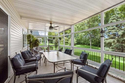 Enjoy the outdoors in comfort from the large screened porch overlooking mature trees and green space. Ceiling fan, generous seating areas, and peaceful surroundings make this an ideal spot for morning coffee or evening relaxation.
