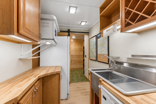 Perfect for entertaining, this convenient lower-level prep area features a sink, cabinetry, countertop workspace, and room for snacks and beverages when hosting family and friends.