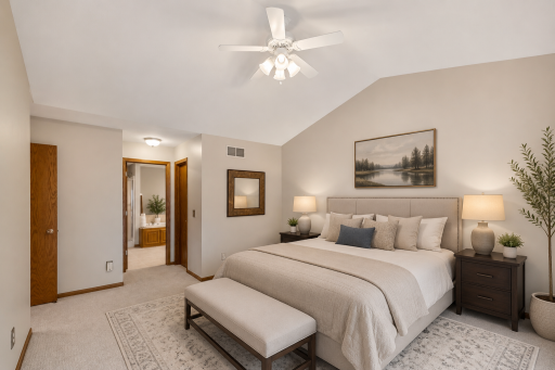 Main level master bedroom with vaulted ceiling and fan. Walk-in closet and private bath. (digitally staged)