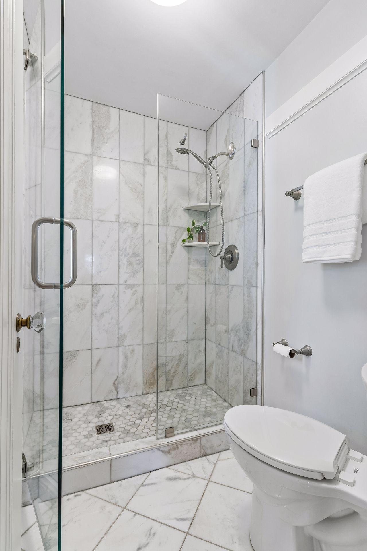 Beautiful tilework adds a touch of luxury and character to this renovated second-level bath.