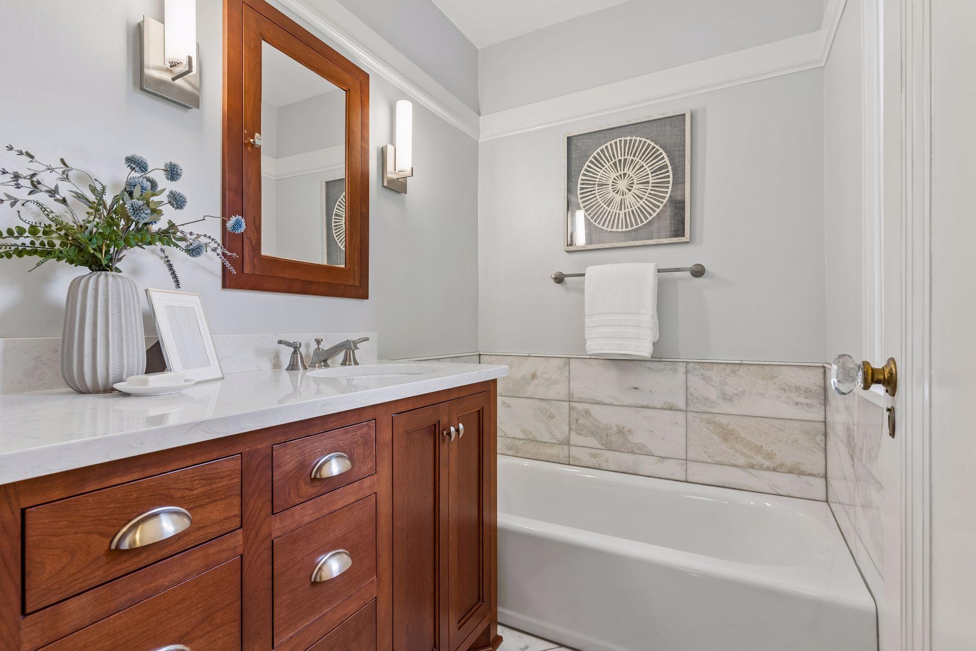 A beautifully renovated full bath on the second level offers modern comfort and timeless style.