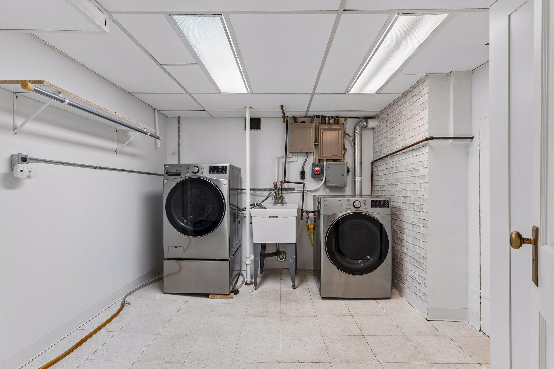 The lower level provides a spacious laundry room and efficient storage solutions for everyday convenience.