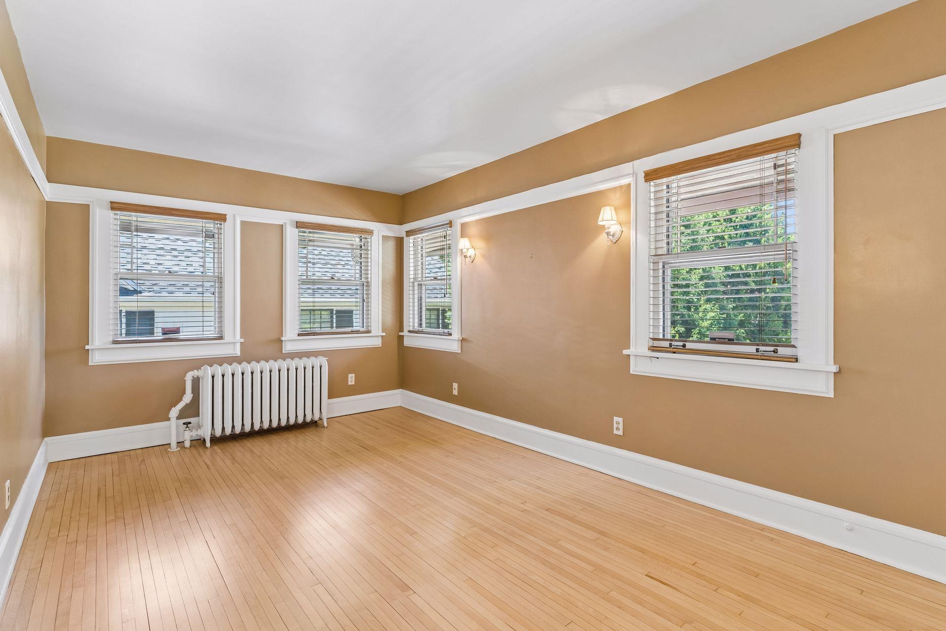 The third bedroom provides a comfortable upper-level retreat with large windows overlooking the surrounding landscape.