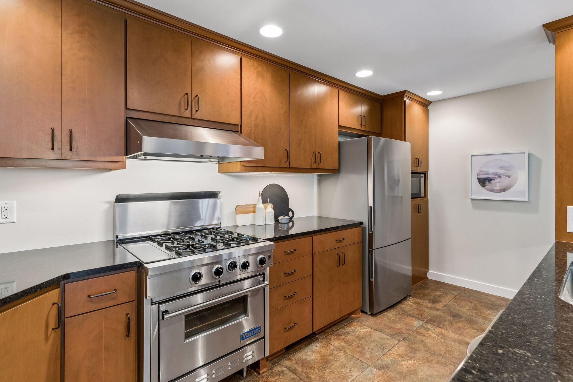 Stainless steel appliances, including a Viking range, complete this exceptional chef’s kitchen.
