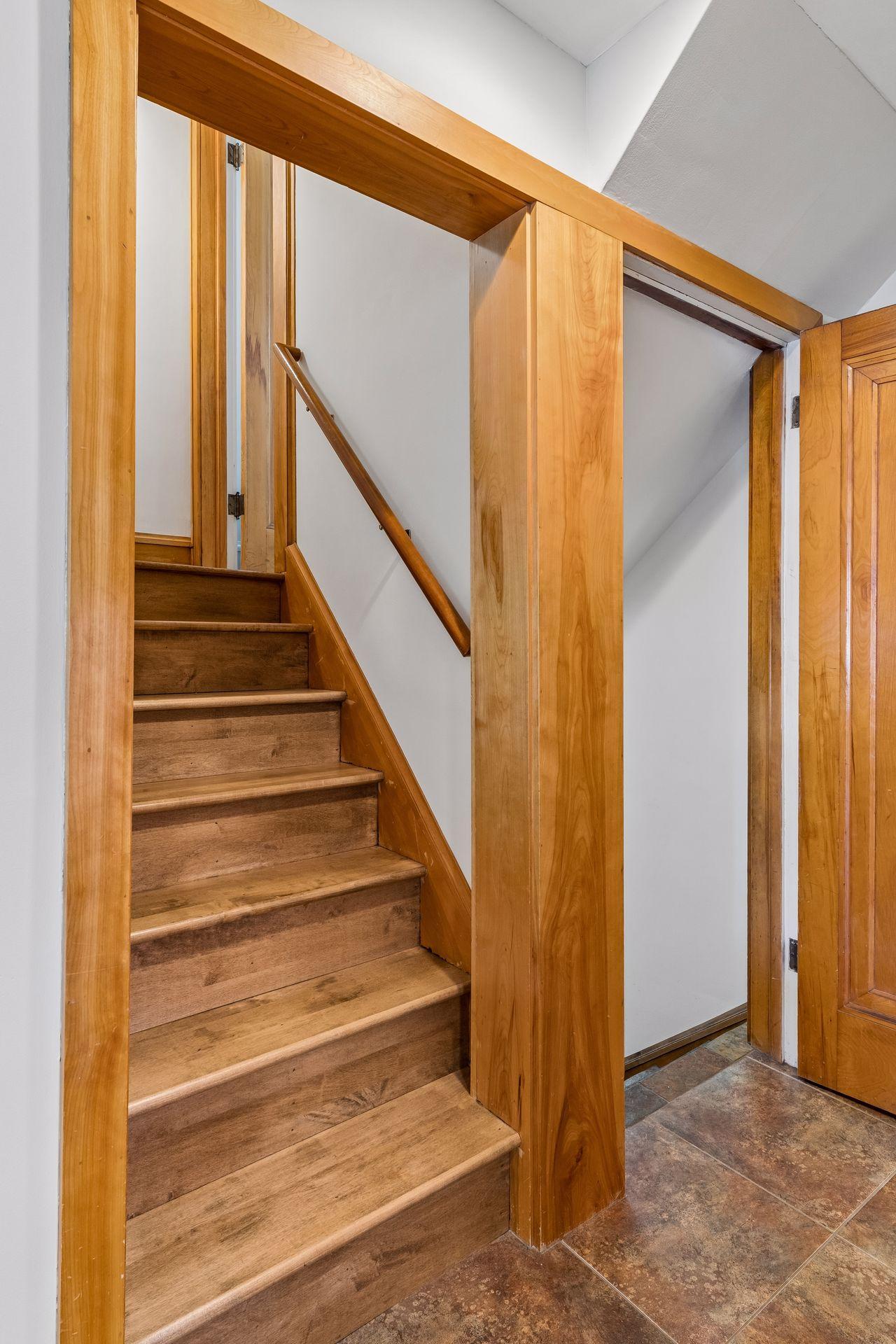 The kitchen connects seamlessly to the upper levels and side entrance for everyday convenience.