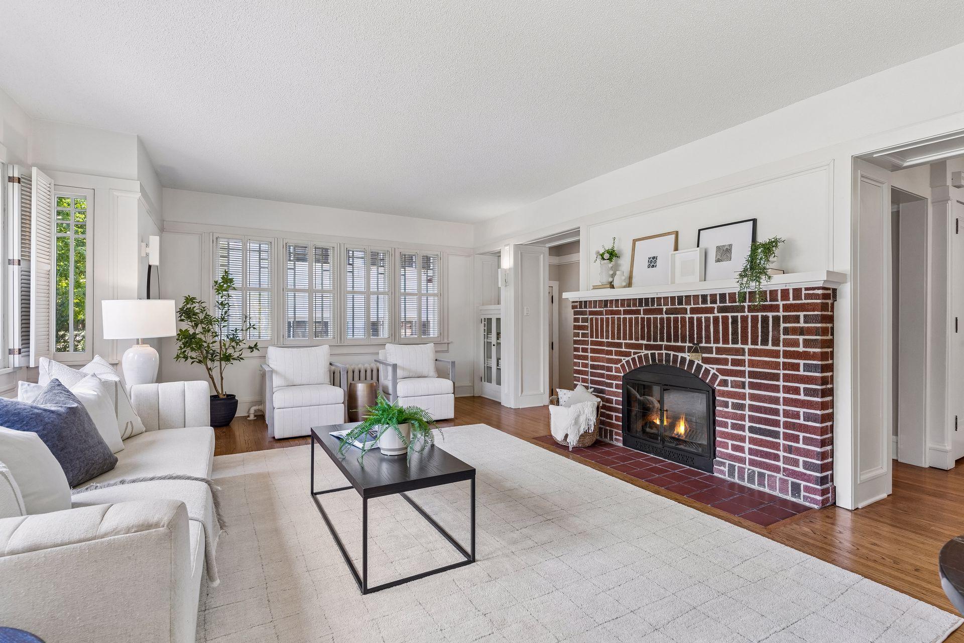 Original character shines through with a classic brick wood-burning fireplace.