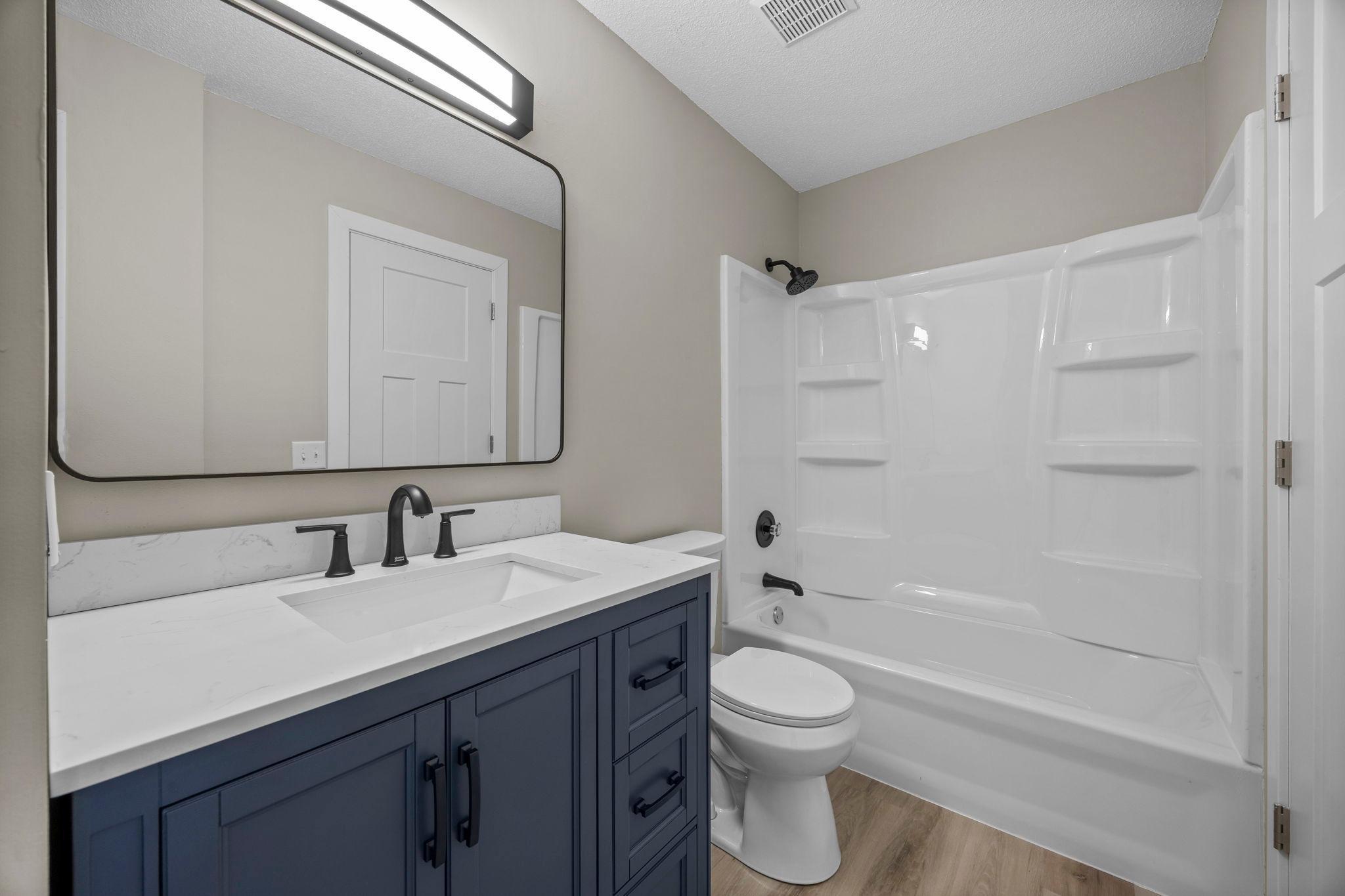 Updated main level full bathroom with new vanity/sink and faucet, a new tub, tub surround and new tub faucet and shower head!