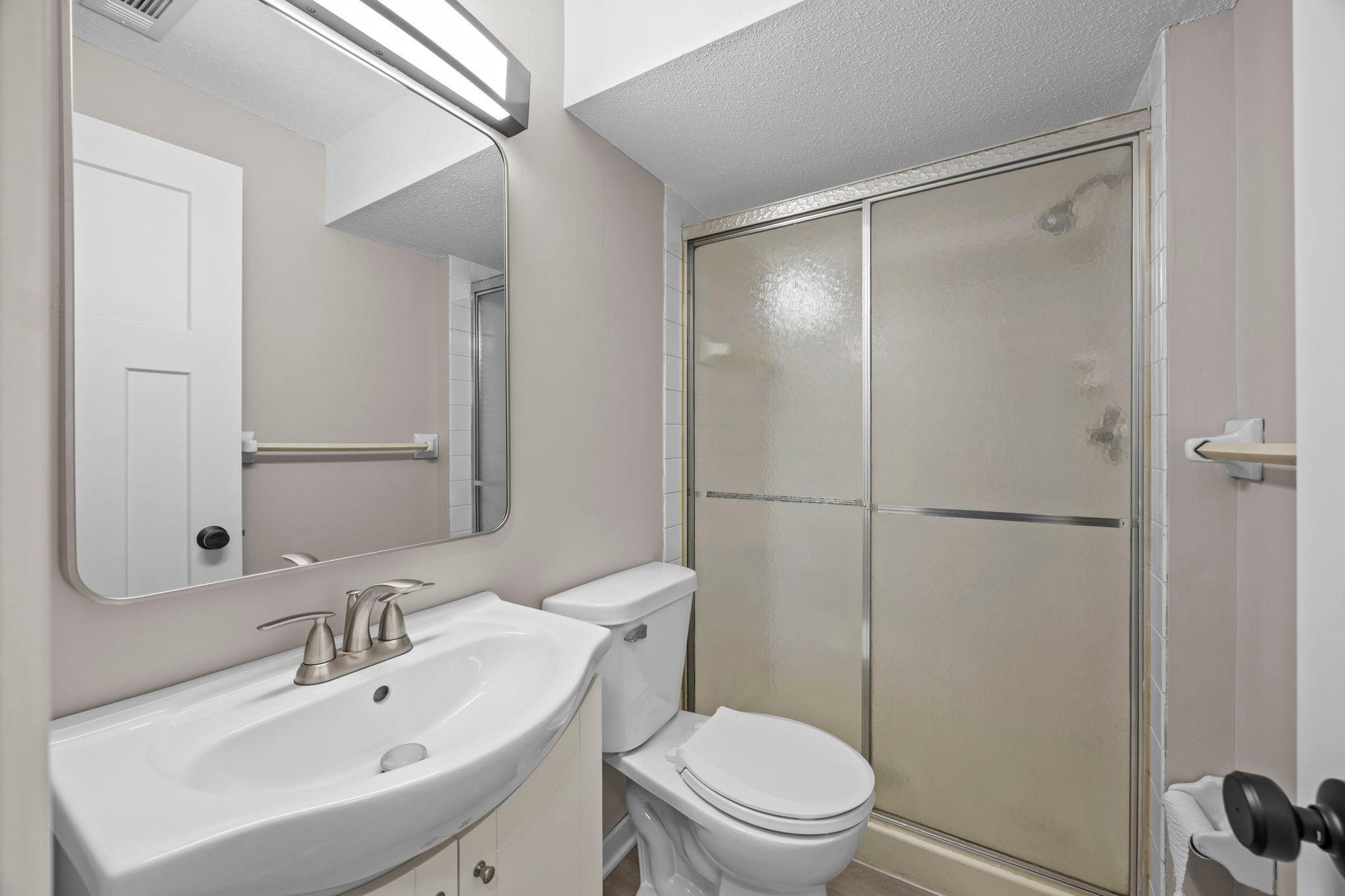 Lower level bathroom with new vanity/sink and faucet, and new plank flooring!