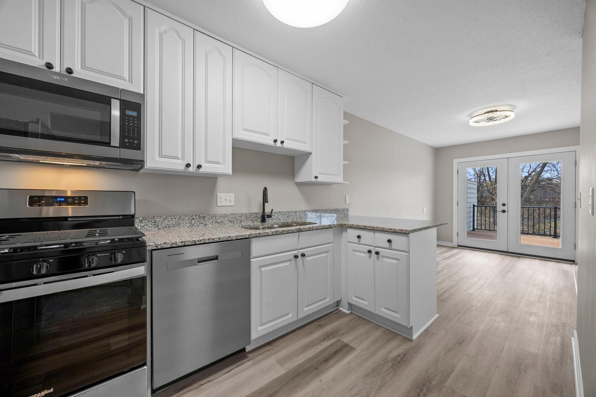 Awesome kitchen with new granite countertops, new stainless appliances and new luxury plank flooring!