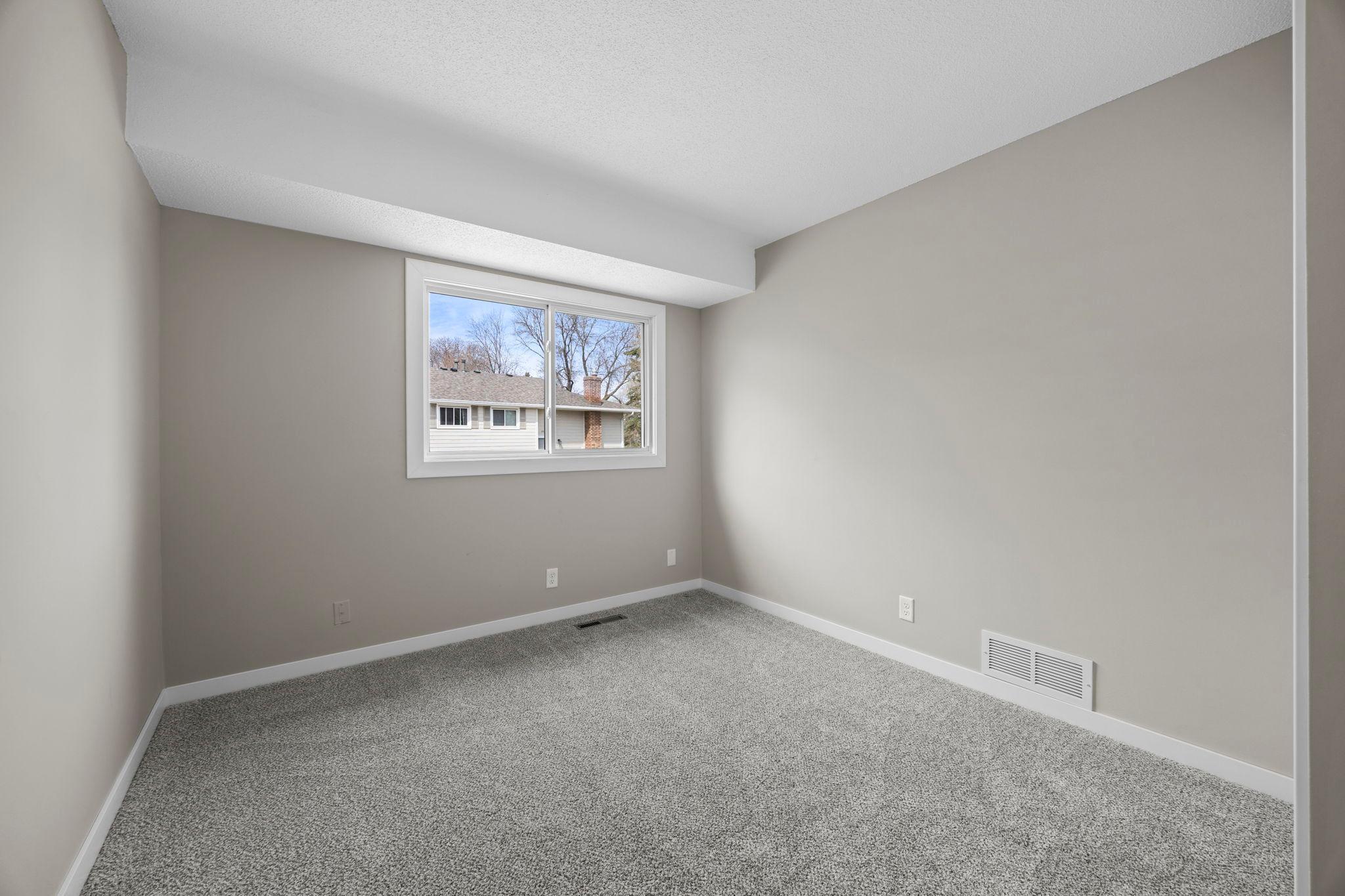 Second main level bedroom with new carpeting, fresh paint and a new bedroom window!