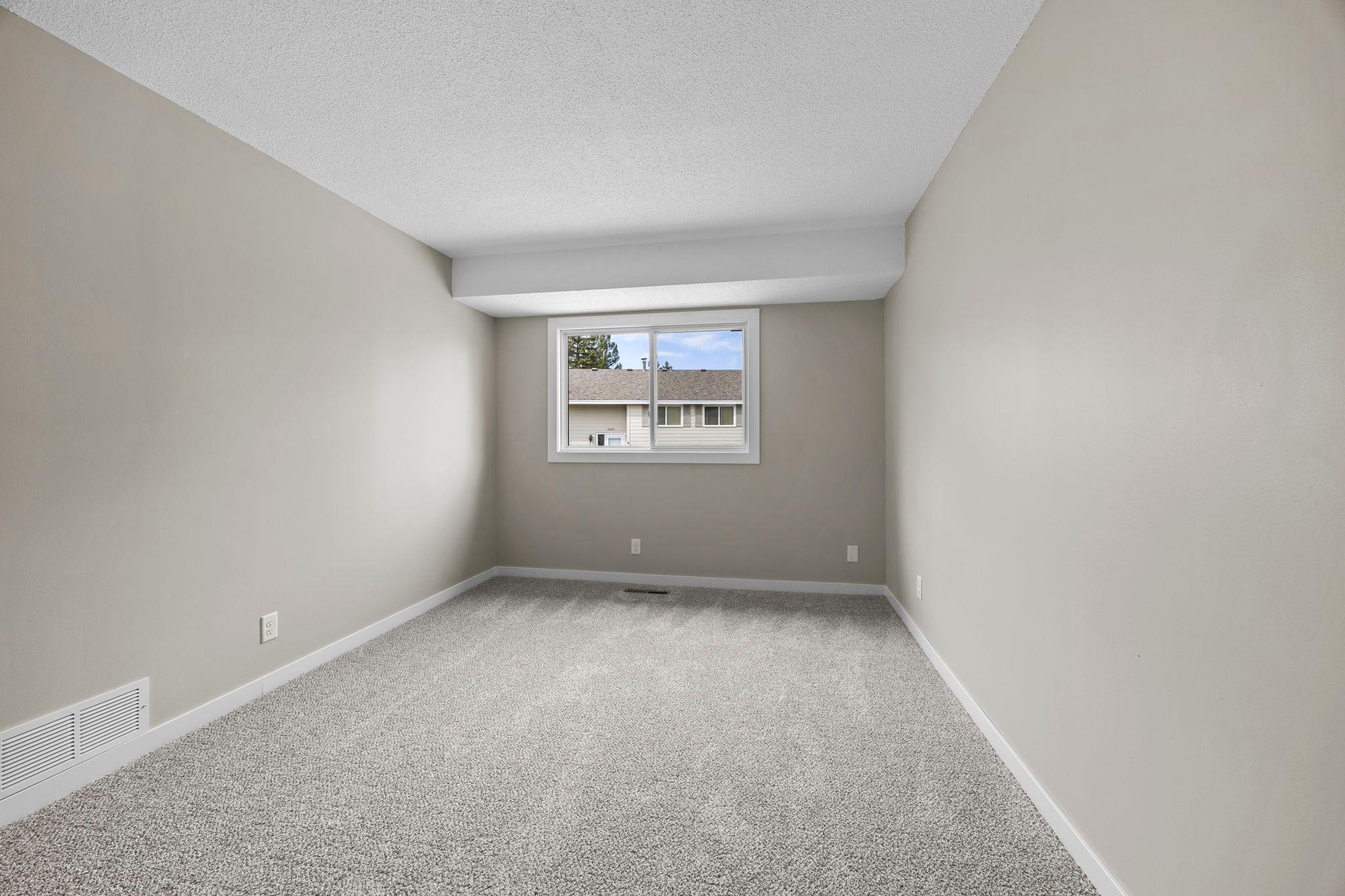 Spacious 16 x 10 foot primary bedroom suite with new carpeting, new bedroom window and new interior doors and trim!