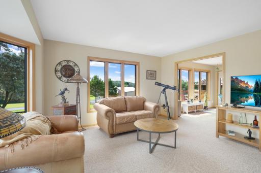 Living room has several windows and lots of natural light at all times of day.
