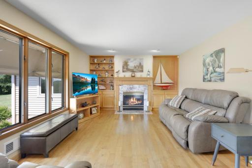 Family room and kitchen feature solid hardwood flooring, lots of windows and a natural gas fireplace.