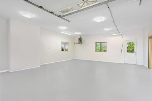 4th stall of attached garage is a room all in of itself with a service door that takes you out to the backyard!