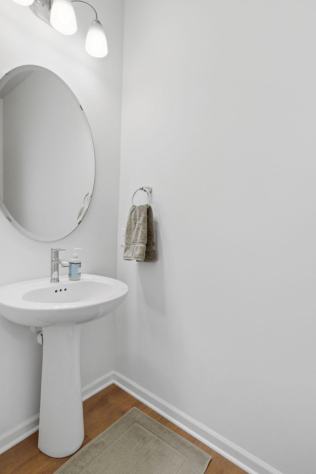 A convenient half bath is located just off the entryway