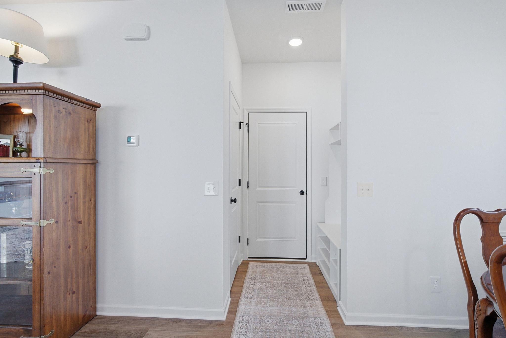 The garage entry features smart storage solutions, with built-in storage on the right and additional compartments on the left for everyday convenience.