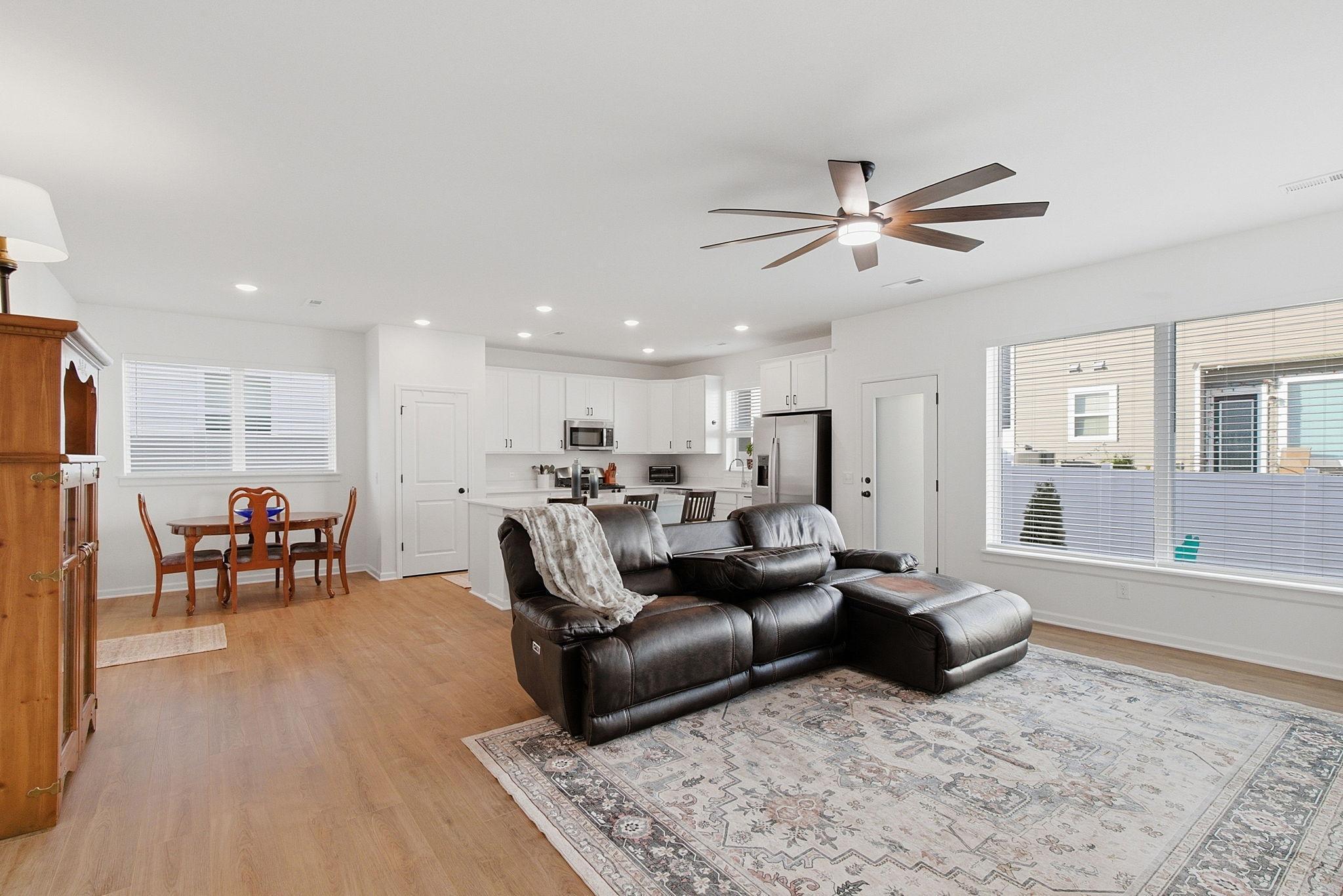 Featuring luxury flooring and stylishly updated ceiling fans throughout the home