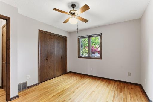 A generous bedroom with hardwood floors and a closet ready for any furniture plan you bring.