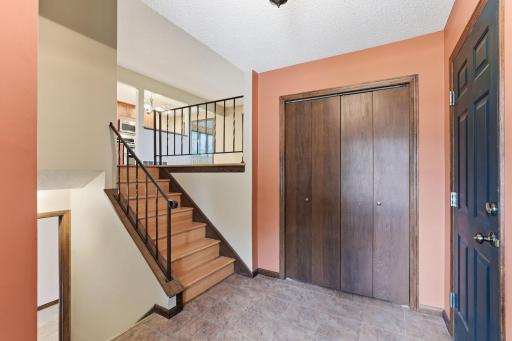Wood treads and wrought iron spindles climb to the open main level, where the kitchen and gathering room sit ready to greet you the moment you step inside.