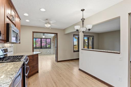 Beautiful counters and a gas range face an open dining area, with the year-round sunroom waiting just through the doorway for slow mornings and evening reads.