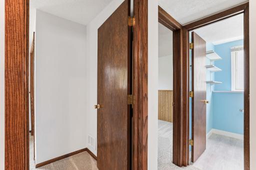 Open doors line the lower-level hallway, connecting bedrooms, the bath, and shared living space without wasted steps.