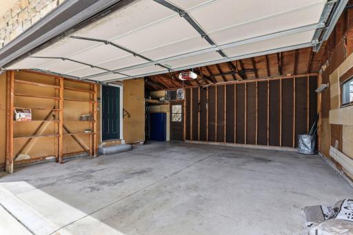 Concrete floor, an automatic opener, built-in shelving, and direct interior entry make the attached two-car garage everyday-ready.