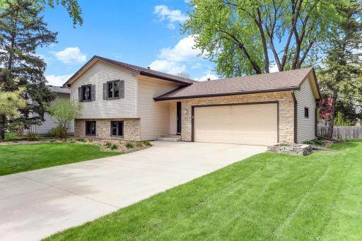 Mature trees and a lush lawn frame the property, offering shade, privacy, and the established neighborhood feel that defines New Brighton's best streets.