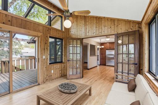 French doors swing open from the sunroom into the kitchen, and the sliding door steps onto the deck in one easy motion for summer entertaining.