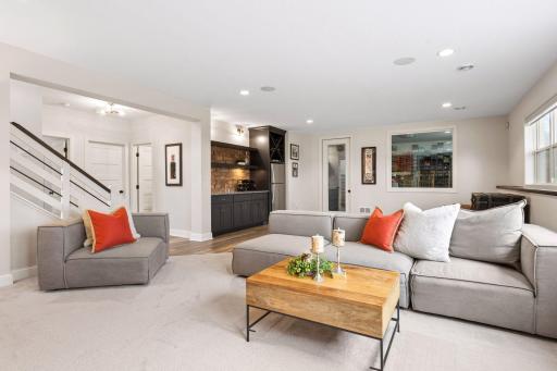 Finished lower level family room, wet bar and entrance to Sport Court