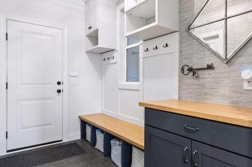 Mudroom with custom cabinets and walk-in coat closet
