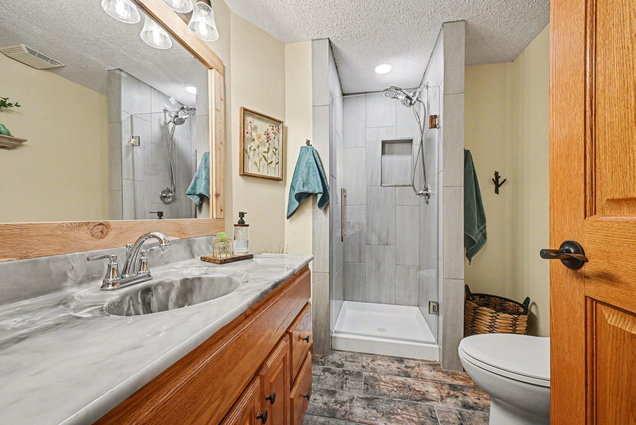 Lower level bathroom with custom tiled walk-in shower