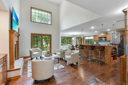 Where do we start! Gorgeous views flood the great room, which features hardwood floors, a soaring 2 story ceiling open to the upper level