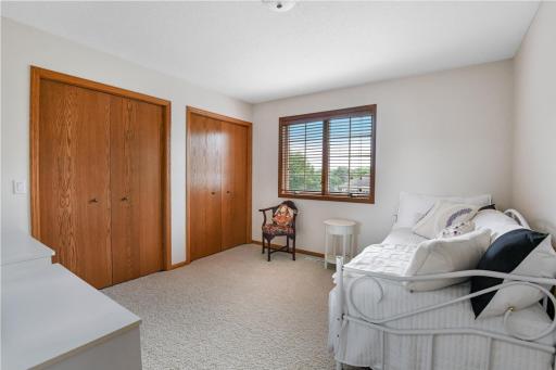 The second bedroom on the upper level features dual closets
