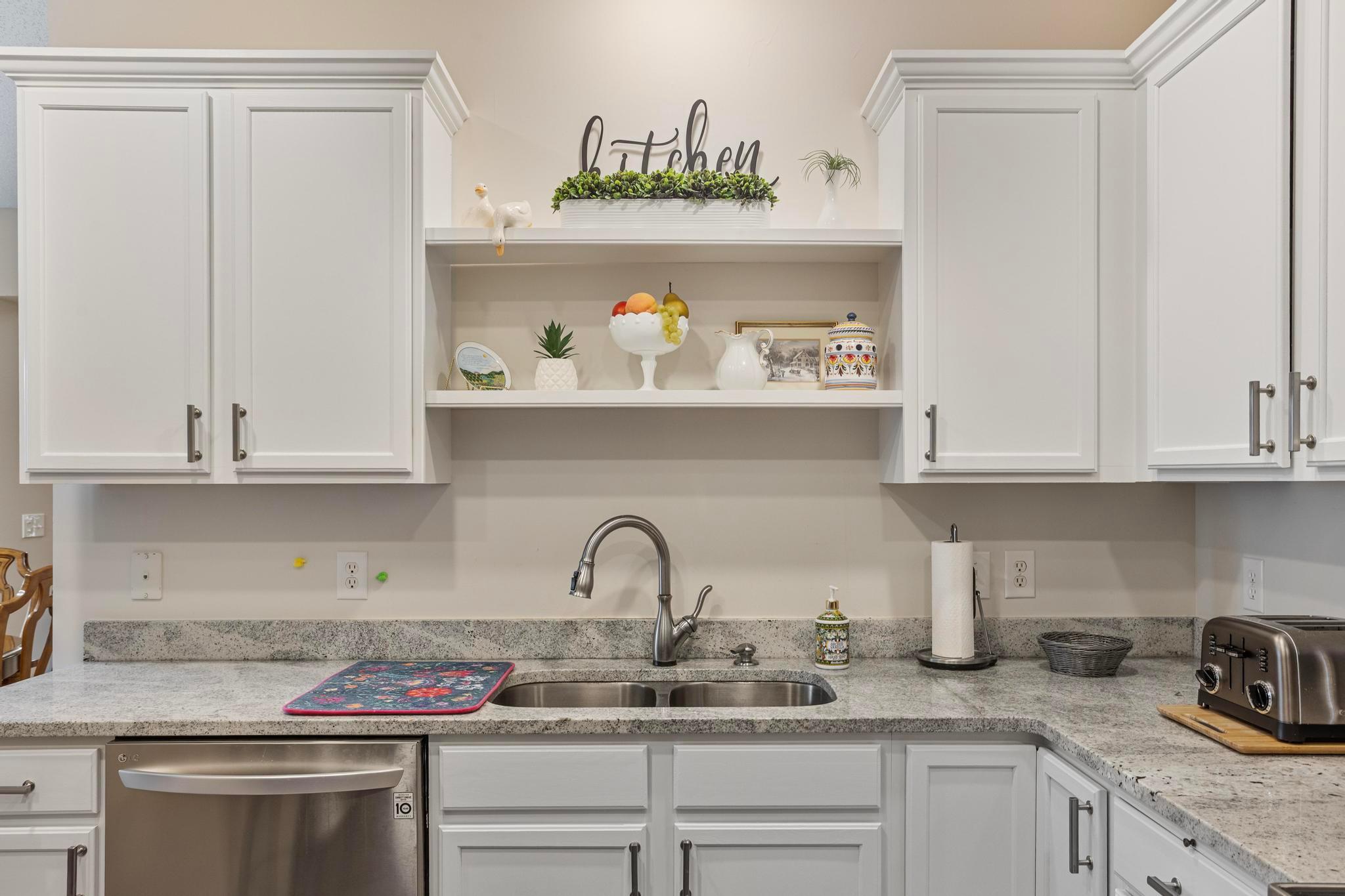 The kitchen is completely remodeled with refreshened cabinets, new countertops, new fixutes and hardware, and new flooring.