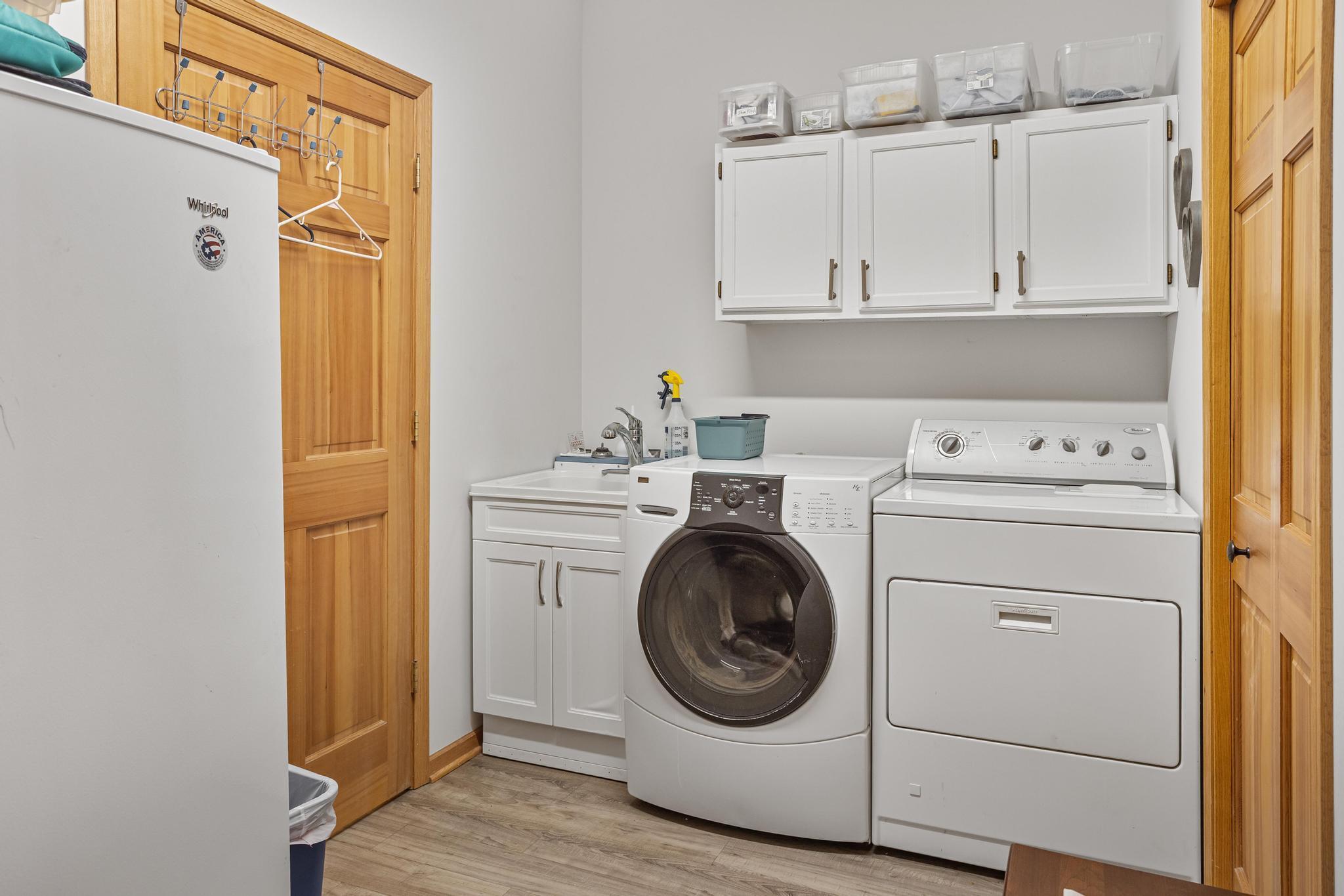 Nicely finished laundry room complete with sink, room for a freezer, and access to the utilities and finished garage.