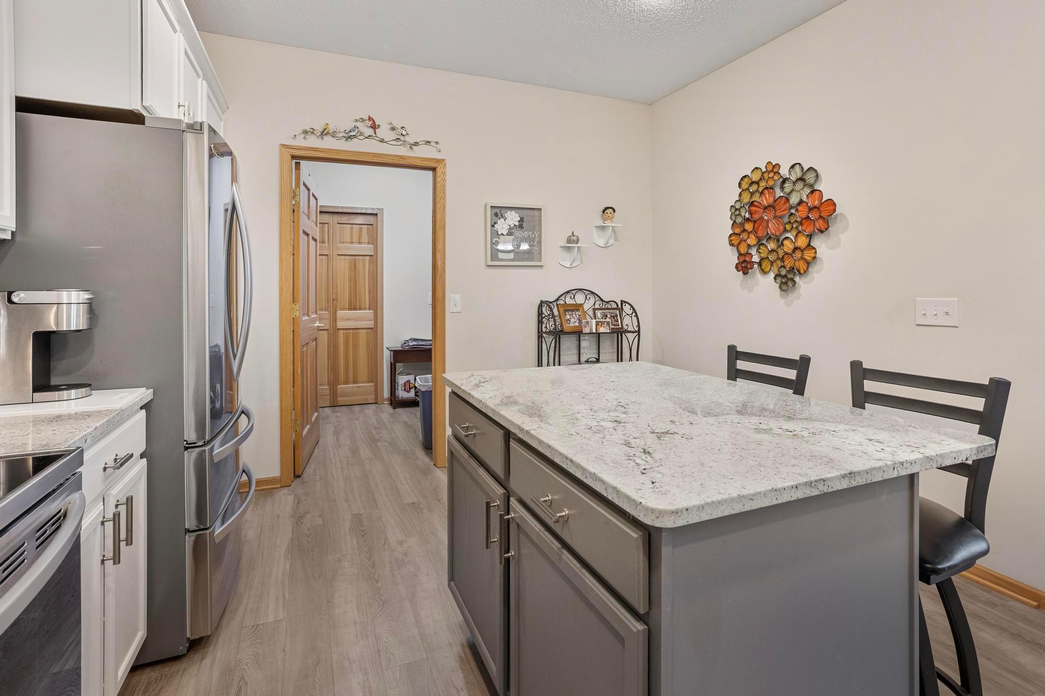 Straight ahead, full laundry room (with space for a freezer), access to the utilities and entrance into the heated garage. t