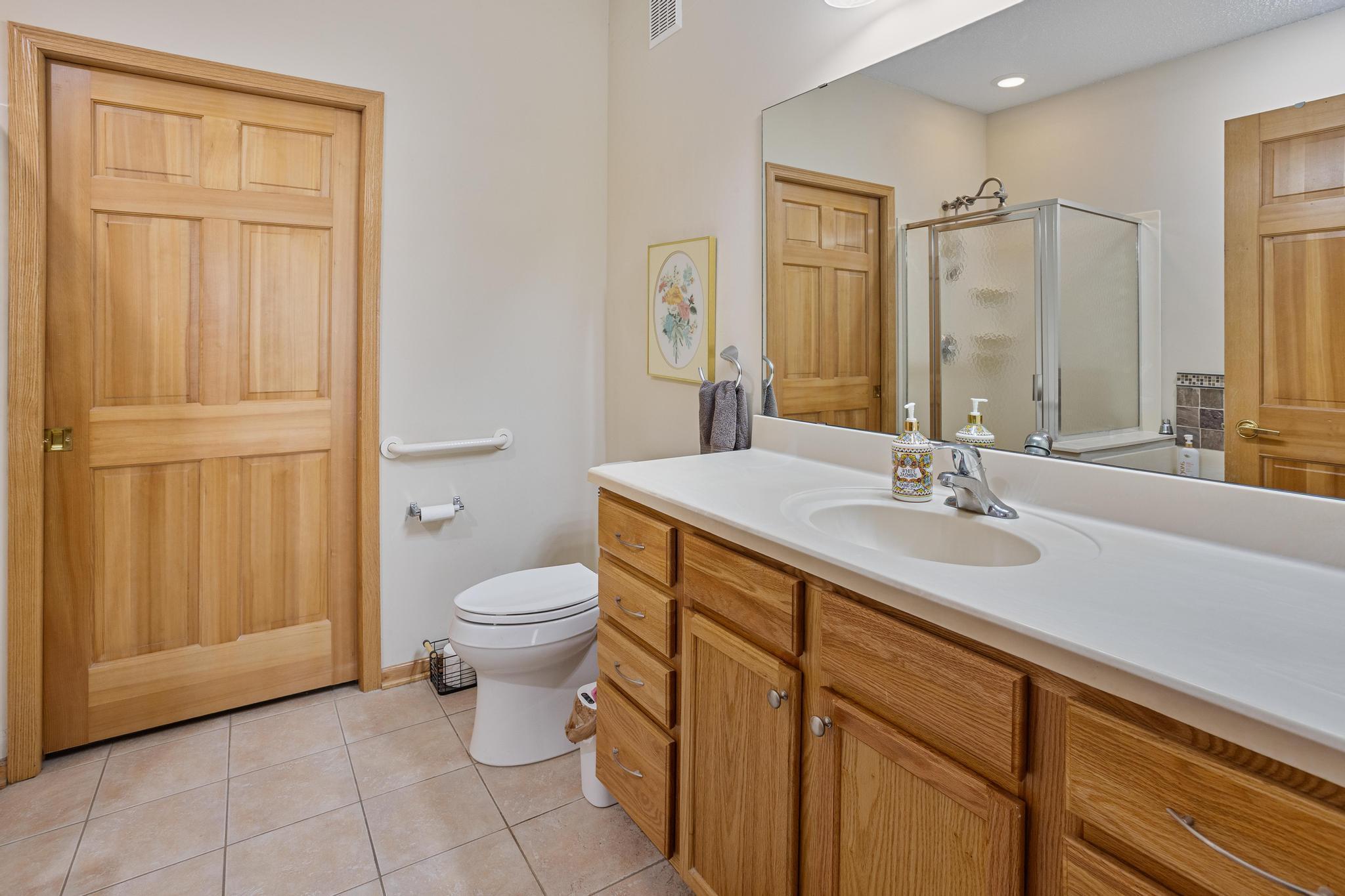 Primary private bath with separate jetted tub and shower.