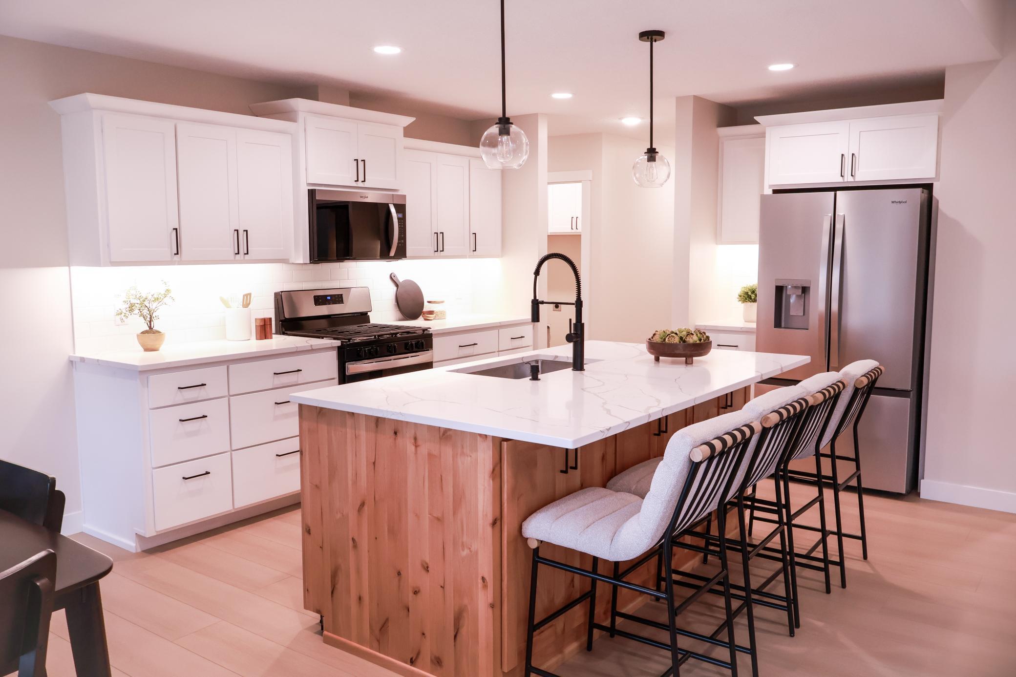 The Kitchen features stainless steel appliances and quartz counter tops