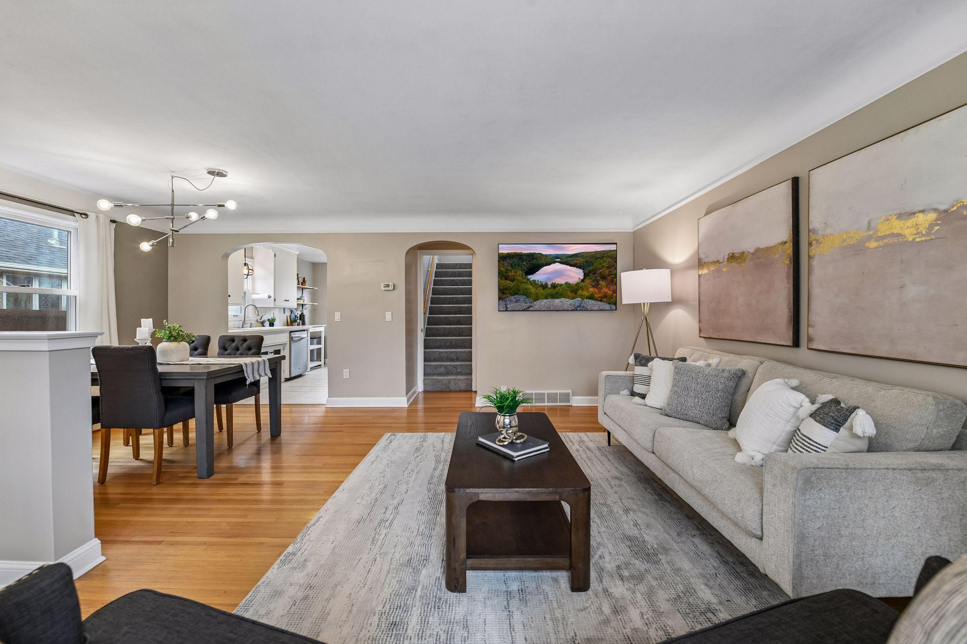 The main level features beautiful hardwood floors, coved ceilings, and charming archways that create an inviting atmosphere.