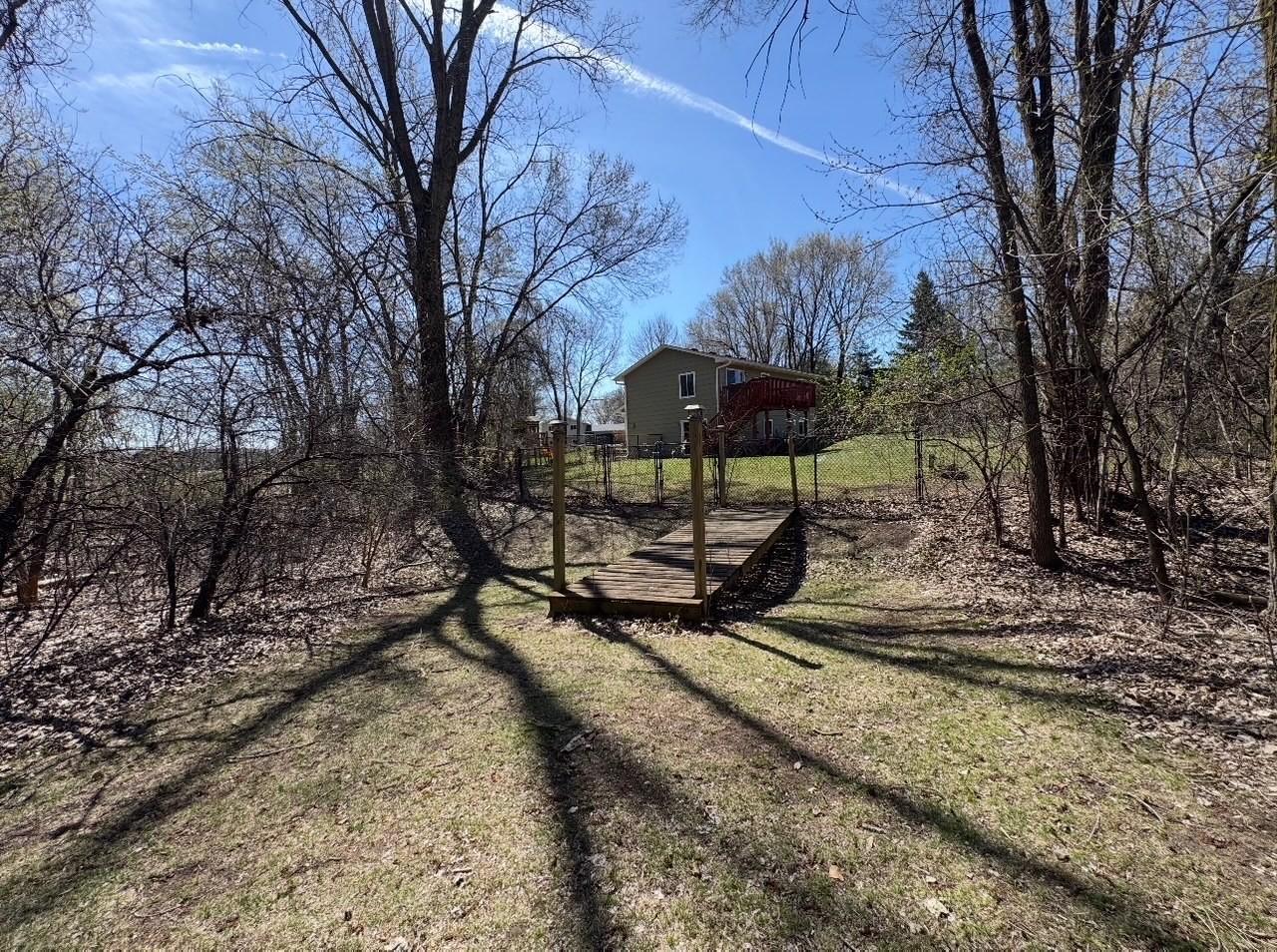 Yard measures just over an acre and extends over the bridge where you'll find additional storage shed, green space and wooden lot.