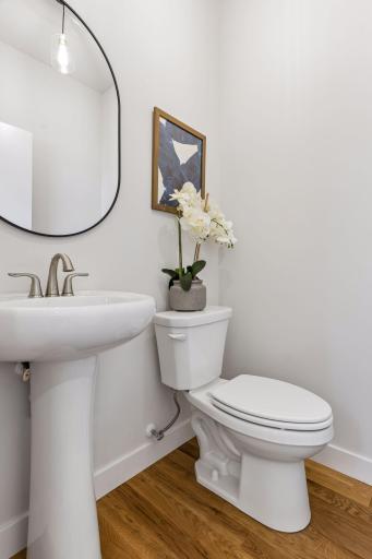 Convenient main level 1/2 bath with modern fixtures, pedestal sink and clean, updated design.