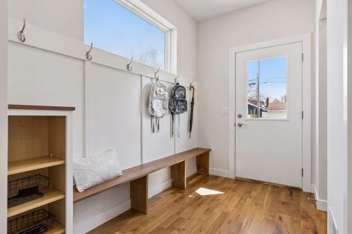 Functional mudroom with built-in bench, hooks, and storage, plus a gigantic closet offering exceptional space for coats, shoes and everyday organization. Convenient drop zone with easy-to-maintain flooring.