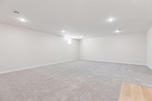 Spacious lower level ready for your vision - movie nights, pool table, or game room setup. Includes wet bar with sink, perfect for adding a beverage fridge and creating your own entertainment space.