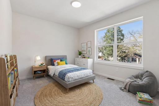 Virtually Staged! Spacious third bedroom on the upper level with large window bringing in natural light, soft carpeting, and neutral finishes - perfect for family, guests or a home office.