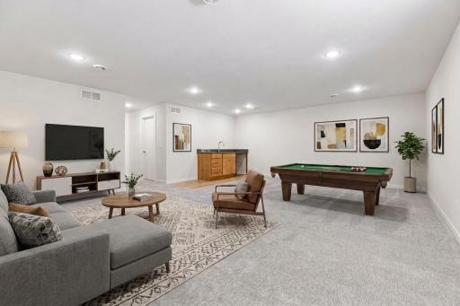 Virtually Staged! Spacious lower-level family room with recessed lighting and soft carpeting - perfect for a movie room, game nights, or entertaining. Wet bar with sink is ready - just add your beverage fridge or mini refrigerator.