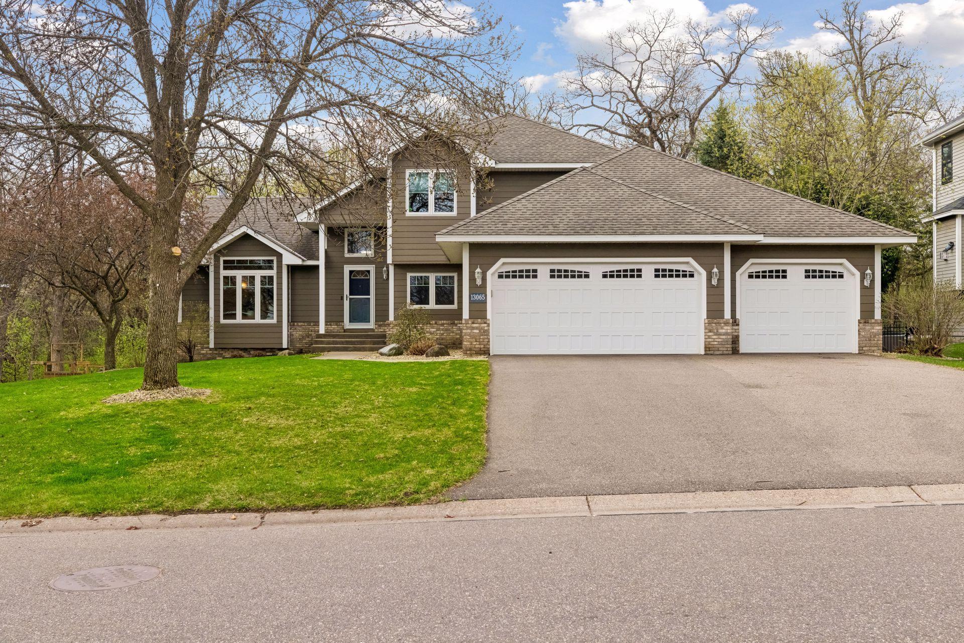 Beautiful curb appeal with stone and Hardie board siding, a spacious three-car garage, and new windows throughout.
