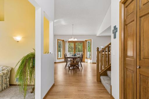 Step inside to a bright foyer with a sunroom to the left and an open flow into the kitchen and living spaces.