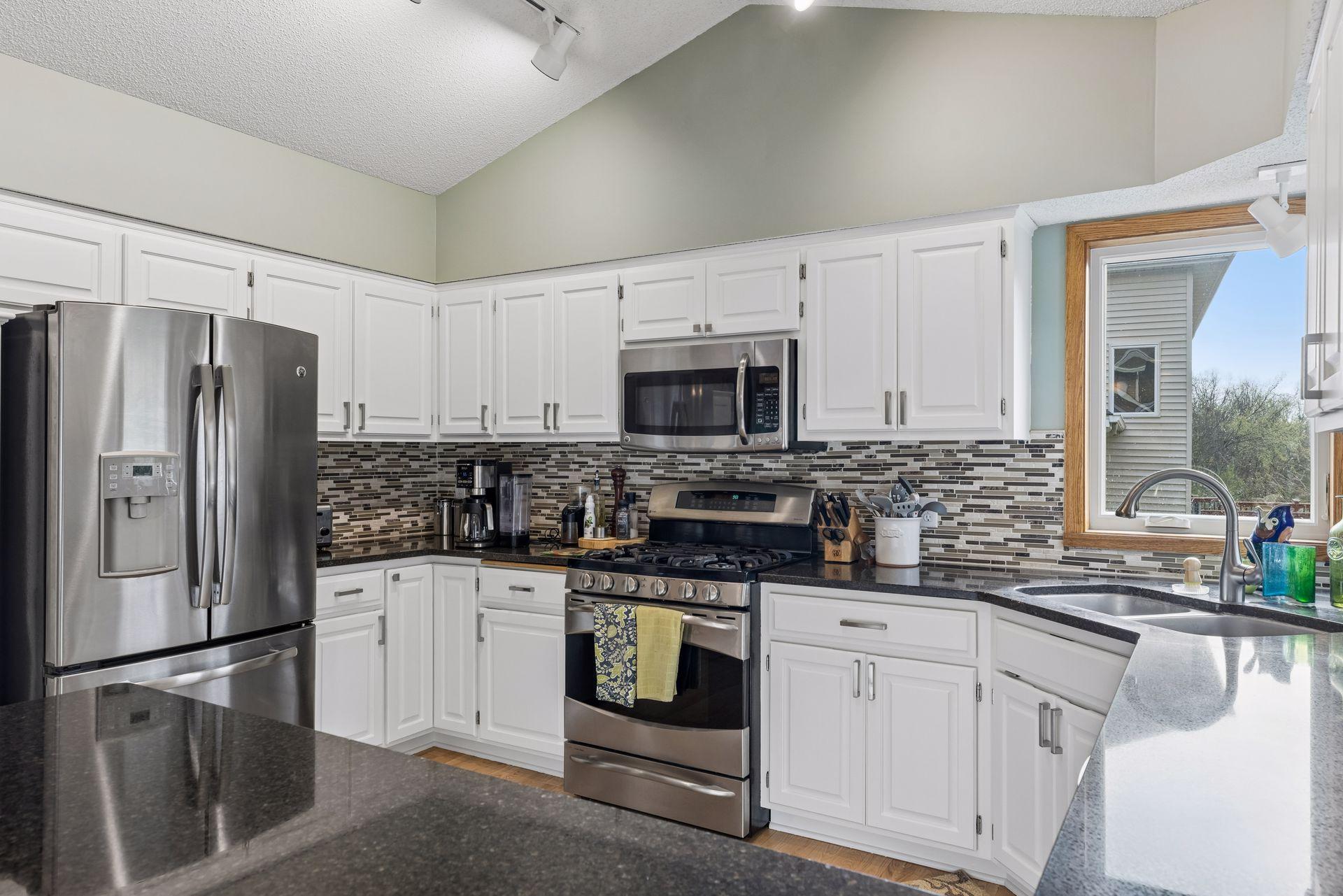 Stainless steel appliances and stone countertops add a modern touch.