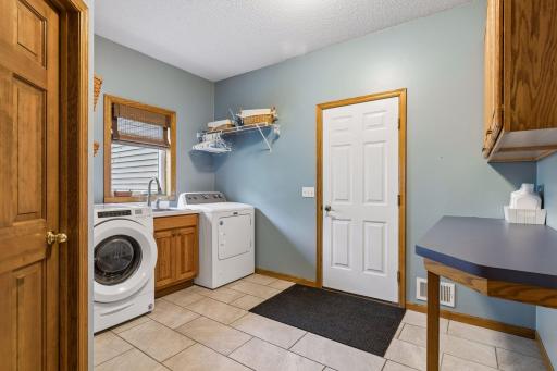 Spacious mudroom and laundry area with great functionality.